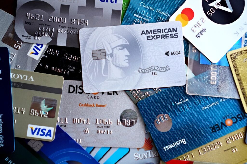 PERSONAL LOAN DEBT CONSOLIDATION Close-up image of various credit and debit cards including Visa, MasterCard, American Express, and Discover.