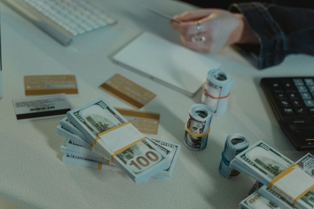 SMALL BUSINESS LOAN Close-up of dollar bills and credit cards on a desk, symbolizing financial transactions.