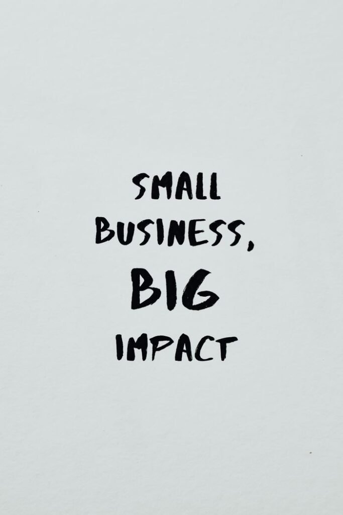 LOAN TO SMALL BUSINESS Motivational text highlighting the impact of small businesses on a minimalist background.